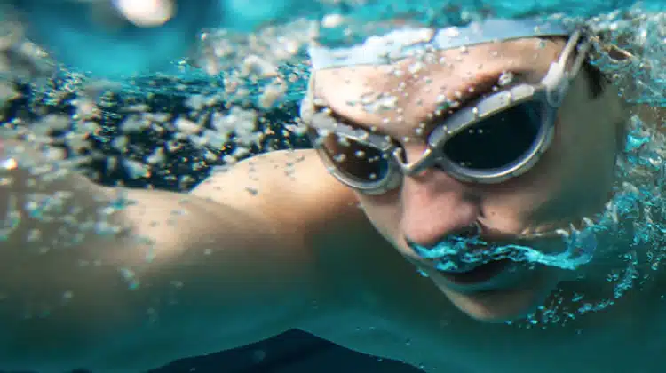 man swimming with goggles