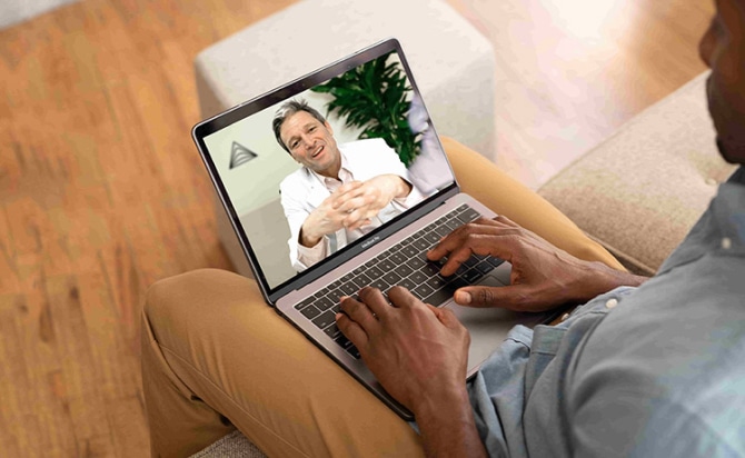 man talking to doctor on computer screen