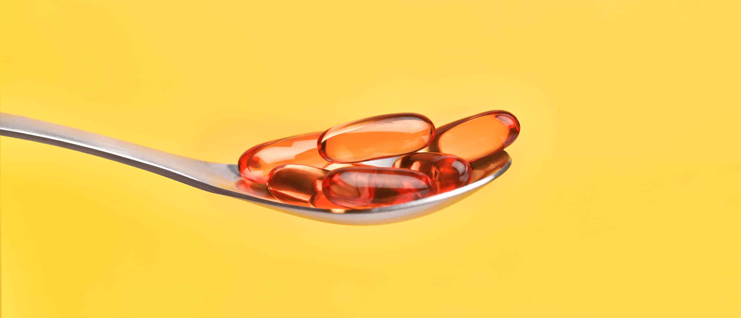 Vitamin D supplements on a spoon