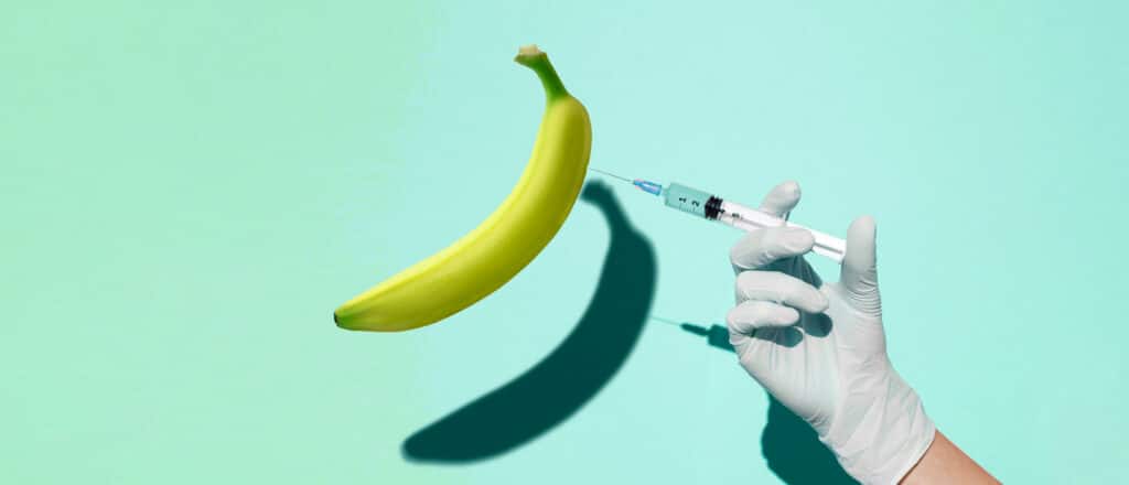 A doctor injects erectile dysfucntion medication into a banana