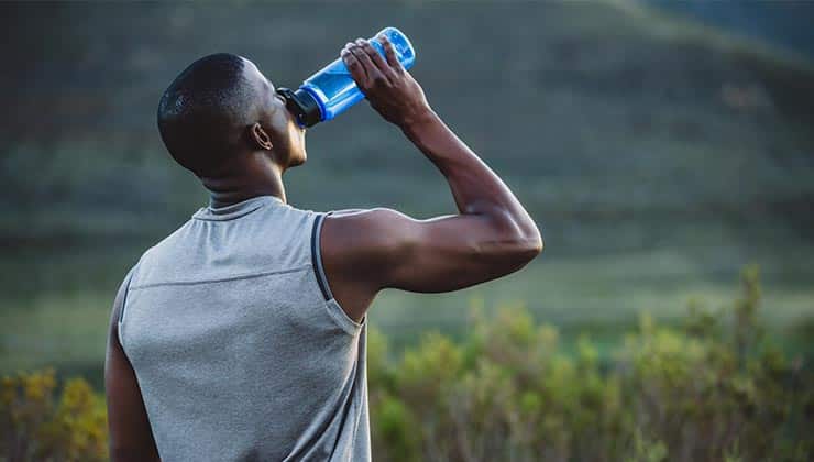 A man drinking water from a sports bottle