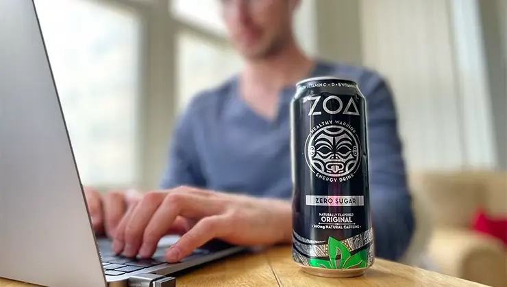 ZOA Energy Drink on desk in front of laptop