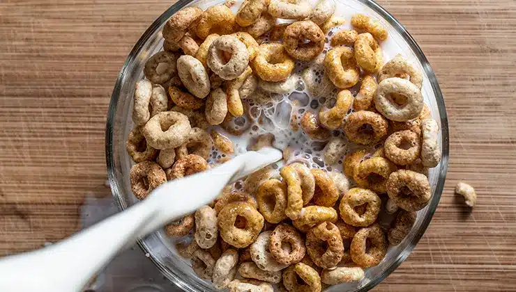cereal in a bowl with milk being poured into it