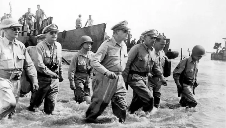 General Mcarthur walking on beach with sunglasses