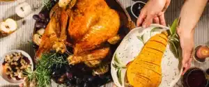 Overhead shot of cooked turkey and squash on table