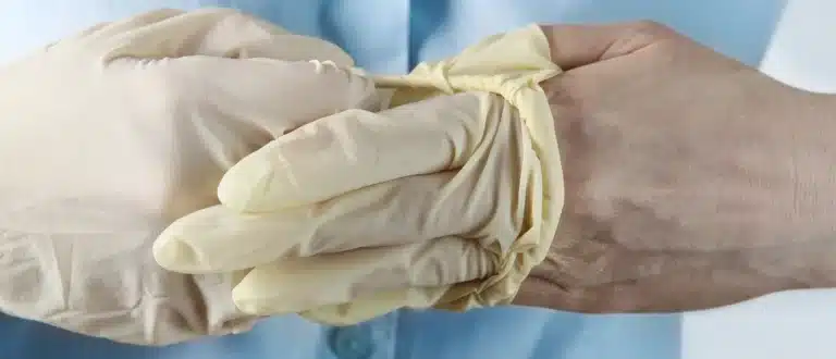 person removing surgical glove off one hand