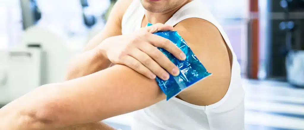 a man holds an ice pack on his arm after a B12 shot