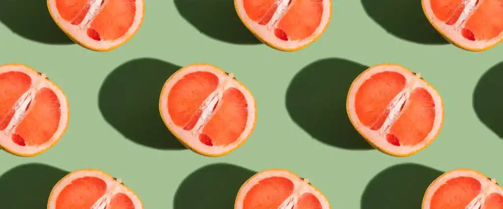 half grapefruits on a green background