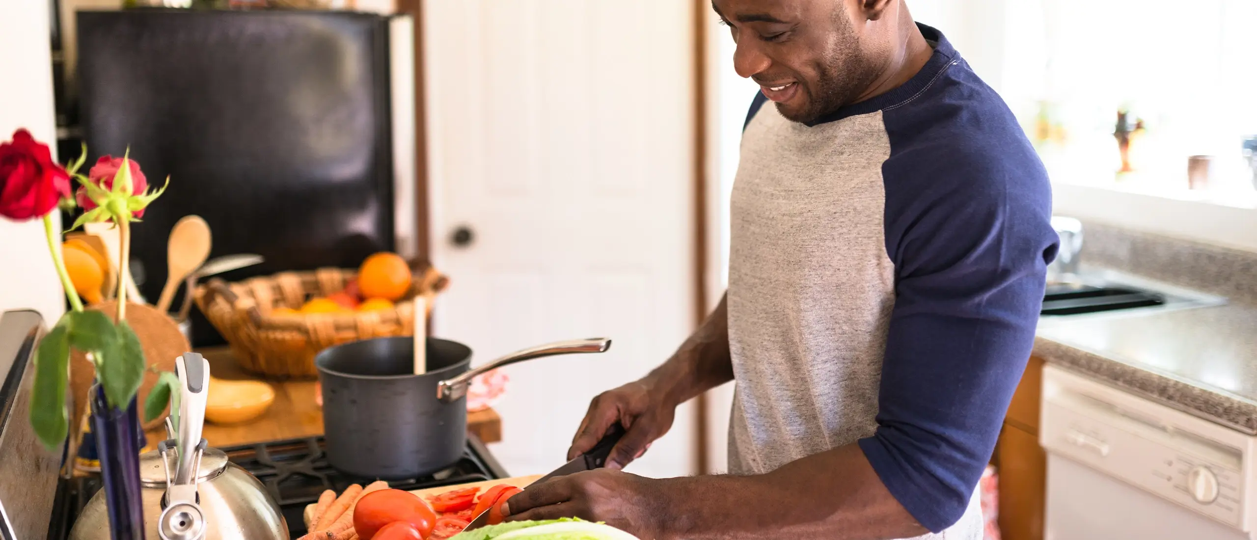 man cutting vegetables in a kitchen