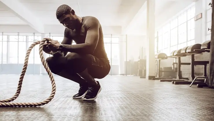 man holding ropes after workout