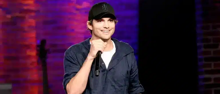 Ashton Kutcher on stage holding microphone
