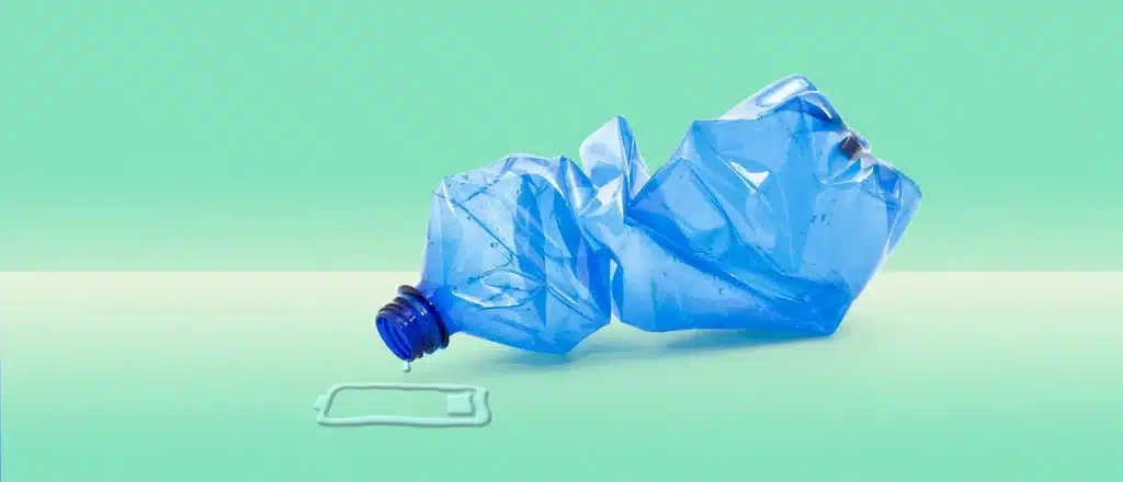 A crumpled water bottle with water in the shape of a drained battery spilling out