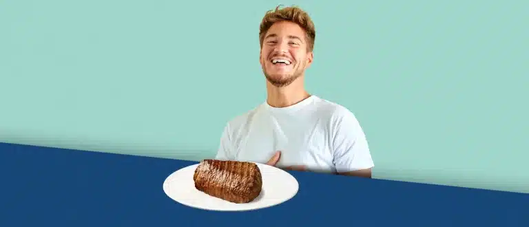 Man sitting at table with a large steak in front of him