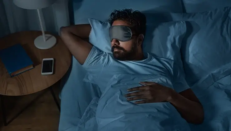 man sleeping with eye mask