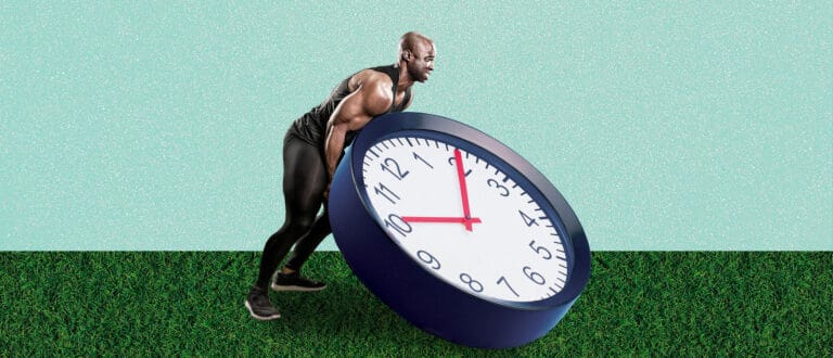 A strong man flips a clock like a tire