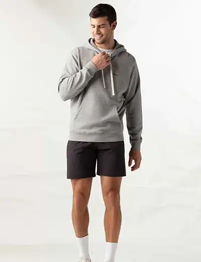 Man standing in hoodie and shorts