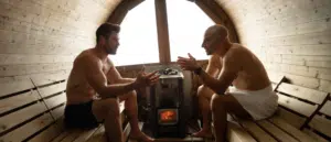 CHris Hemsworth and Peter Attia sitting inside a sauna