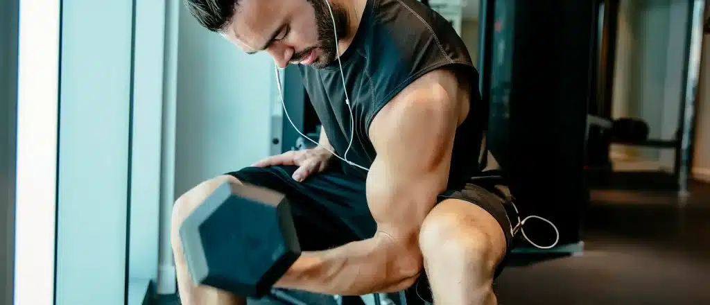 Buff dude doing seated bicep curl