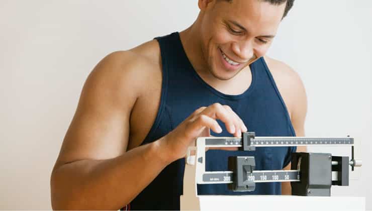 Man checking body weight on scale