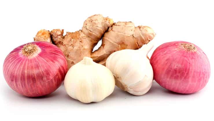Onion, garlic and ginger on white background
