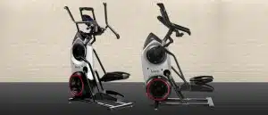 Two Bowflex Max Trainers on a gym floor with white brick walls