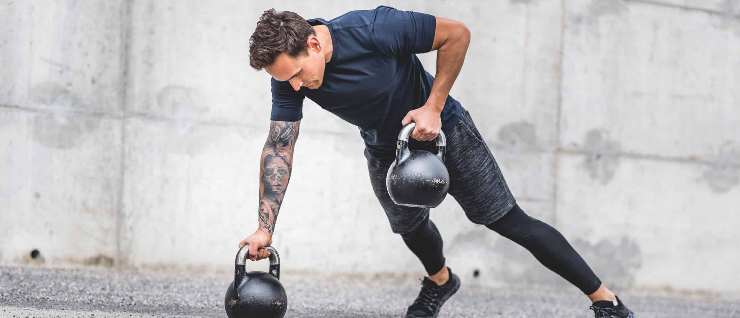 Man doing exercise with kettlebells