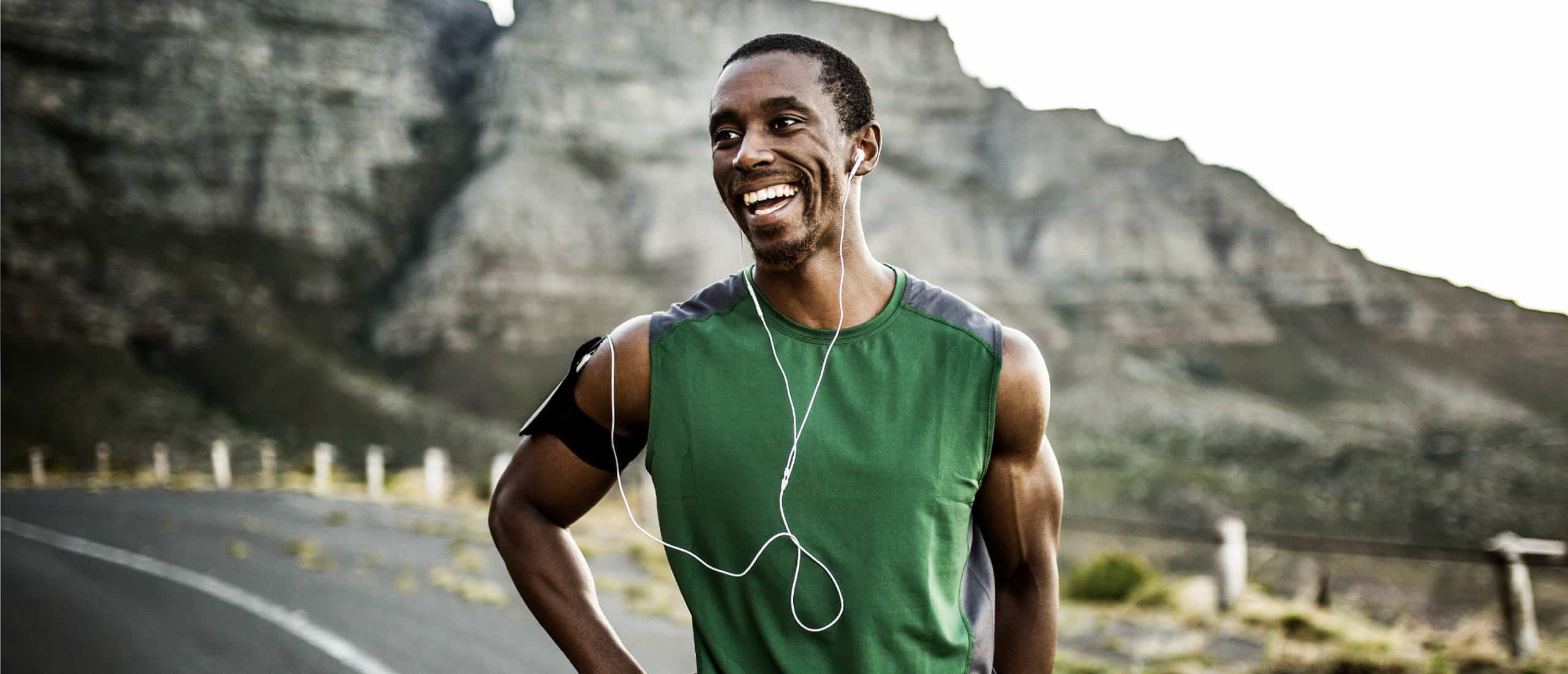 Man smiling after long run in the mountains