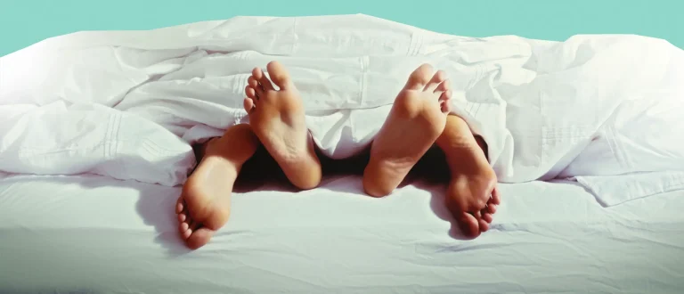 couple feet hanging off bed