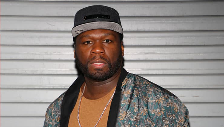 50Cent standing in front of wall