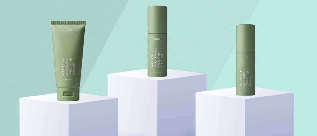 Asystem Skincare products on white pedestal with green background