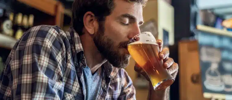 Man taking sip of beer