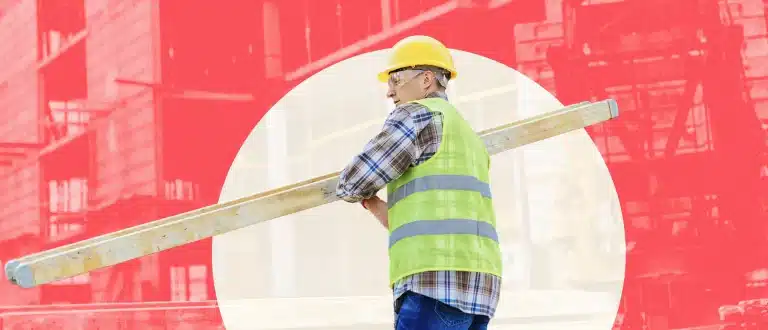Construction worker carrying ladder