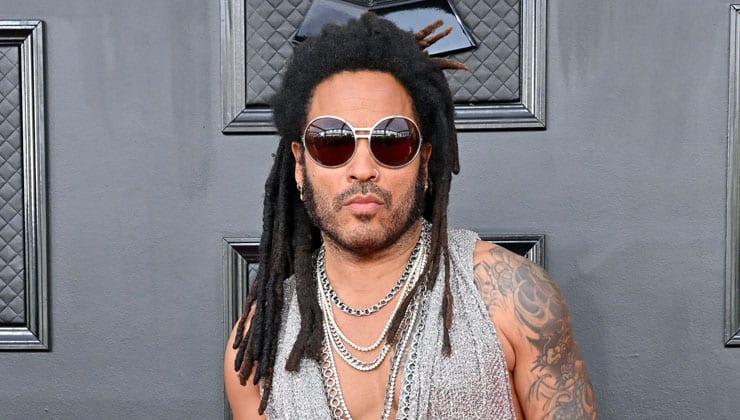 Lenny Kravitz standing in front of black wall