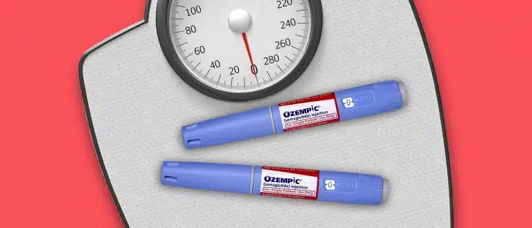 Ozempic injections on weight scale with red background