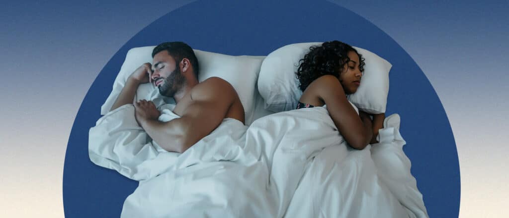 Man and women sleeping back to back on blue background