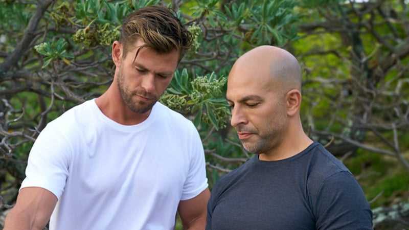 Chris Hemsworth and Peter Attia stand side by side, looking down