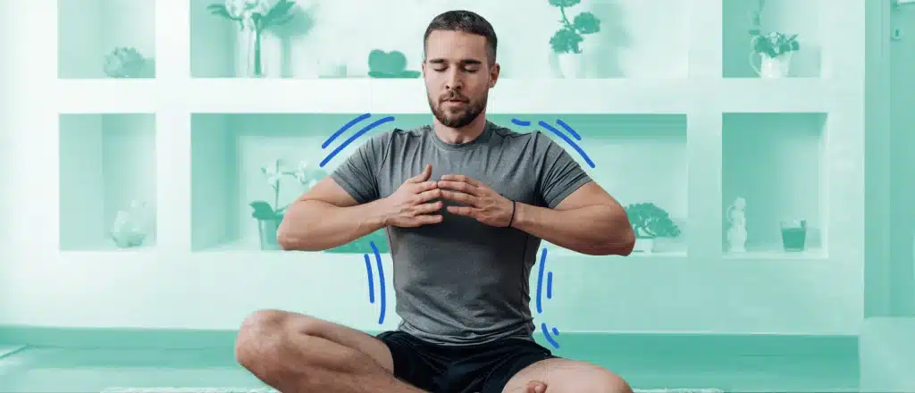 Man doing yoga pose and doing a deep breath with green background