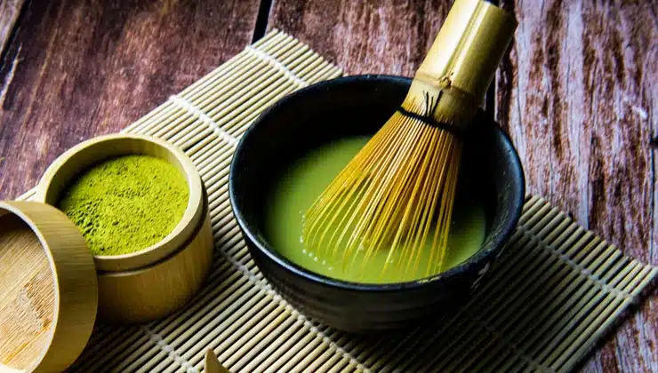 Bowl of matcha and whisk on counter