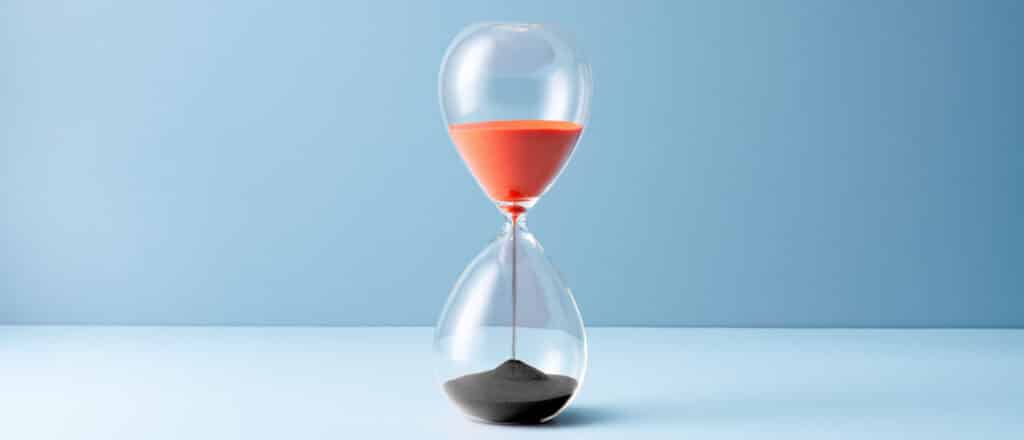A hourglass's sand turns from red into black as it counts down
