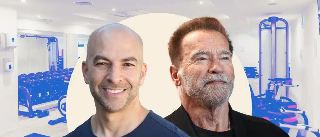 Peter Attia and Arnold Schwarzenegger smiling at the gym