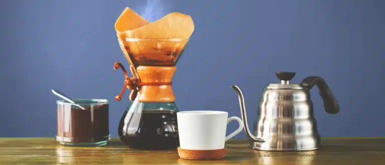 Coffee drip, kettle and mug on countertop