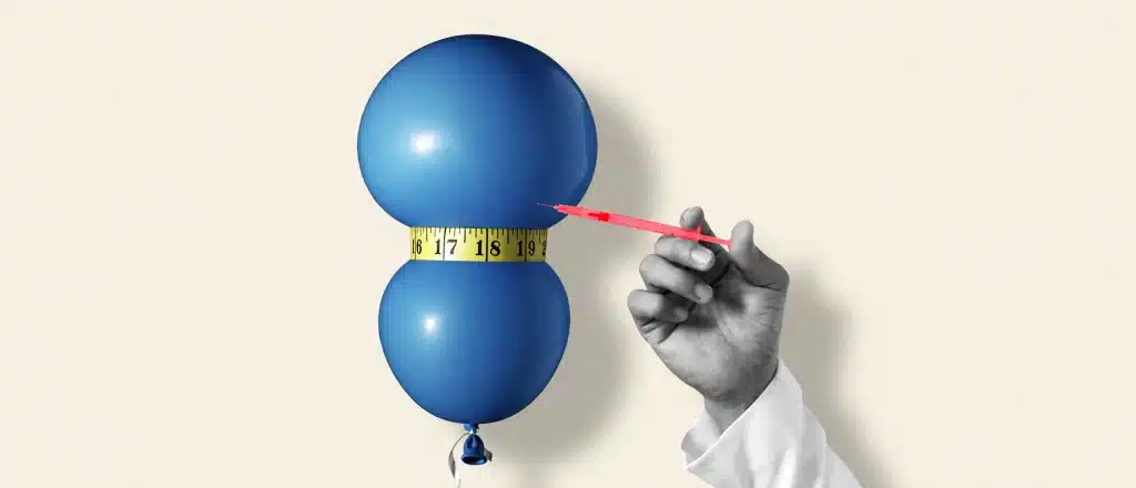 Blue balloon with measuring tape squeezed around it and a doctors hand holding a syringe pointing at the balloon