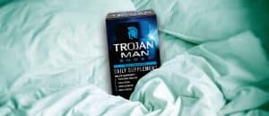 Trojan Man Boost daily supplement in bed covers