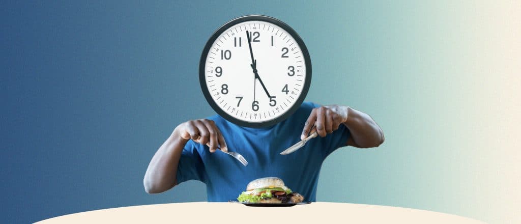 man eating with a clock as his head.
