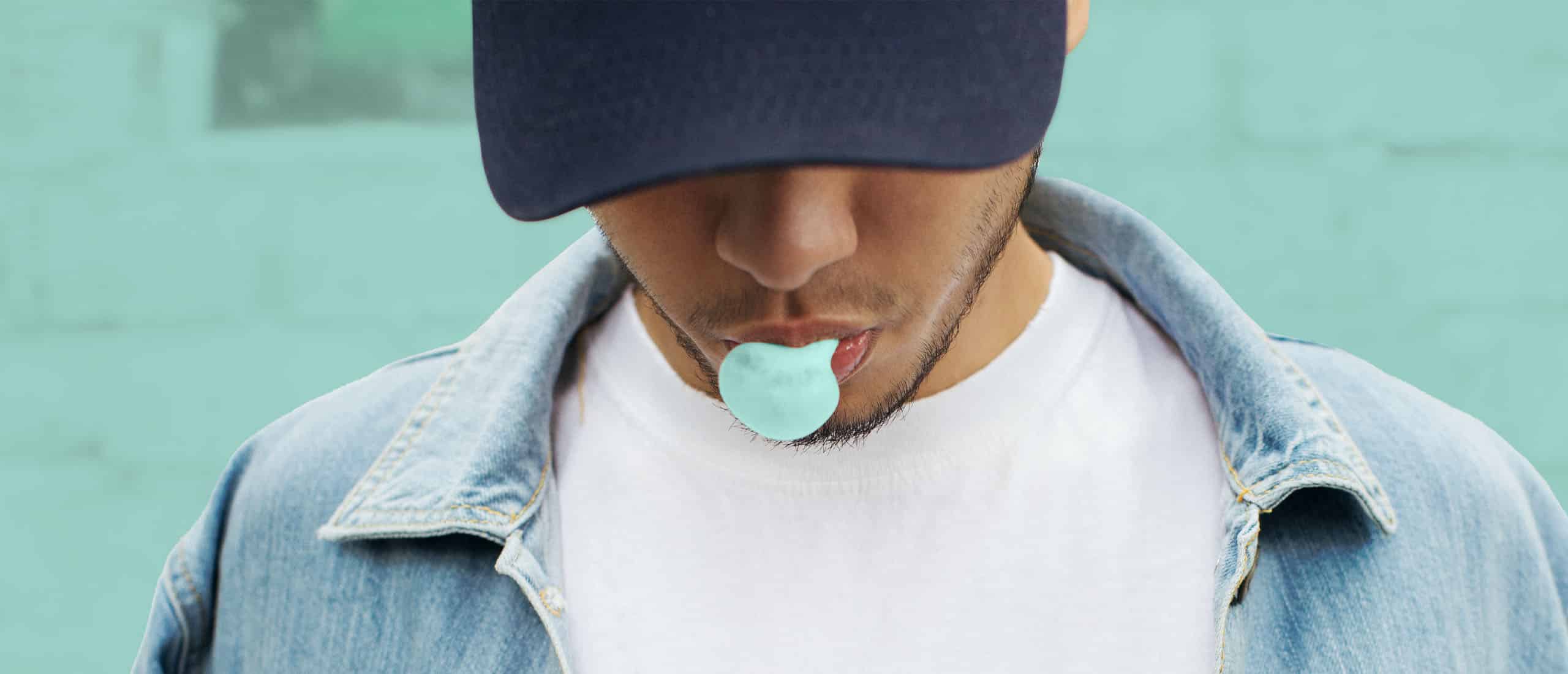 Man chewing gum and blowing bubble