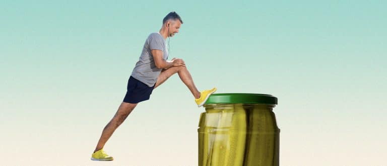 man stretching on a pickle jar