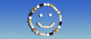Supplements in the shape of a smiley face on blue background