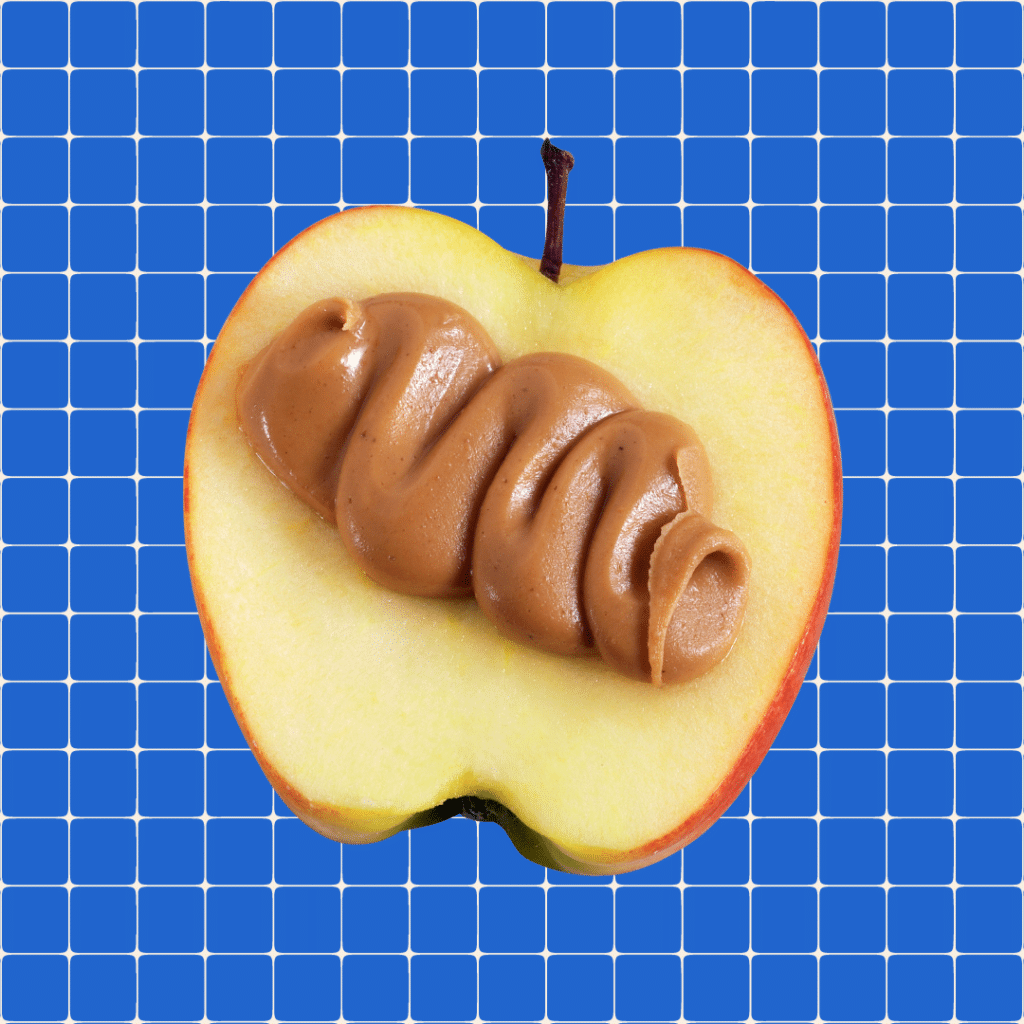 apple and peanut butter on blue grid background