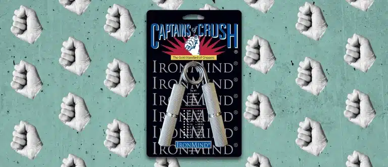 captains of crush gripper tool on green background with fists