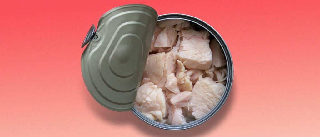Canned chicken with the lid cracked open
